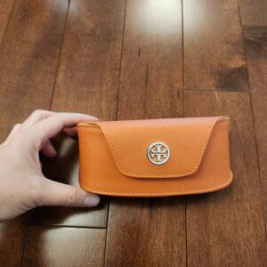 Tory Burch orange eyewear case in a semi-hard saffiano leather